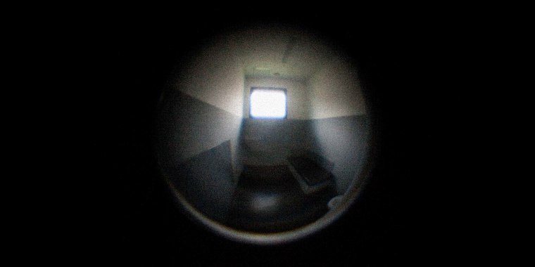 Photo Illustration: A view through a fisheye lens of an empty solitary confinement prison cell