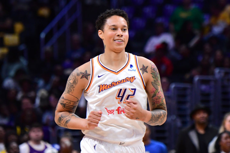 Brittney Griner smiles on the basketball court during her first WNBA regular-season game