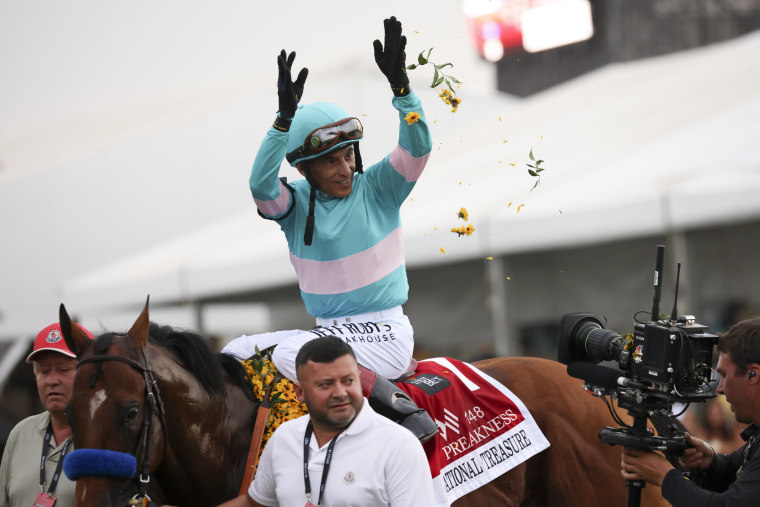 John Velazquez, atop National Treasure, celebrates after winning the 148th Preakness Stakes at Pimlico Race Course, Saturday, May 20, 2023, in Baltimore.
