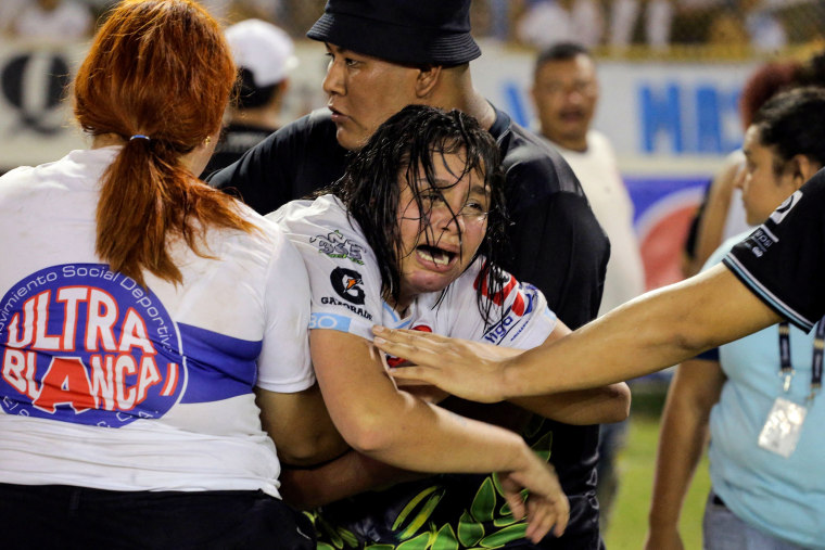 A woman cries following a stampede during a football match between Alianza and FAS at Cuscatlan stadium in San Salvador, El Salvador, on May 20, 2023.