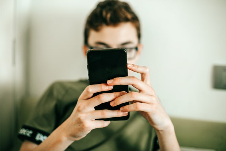 teenager texting on mobile phone