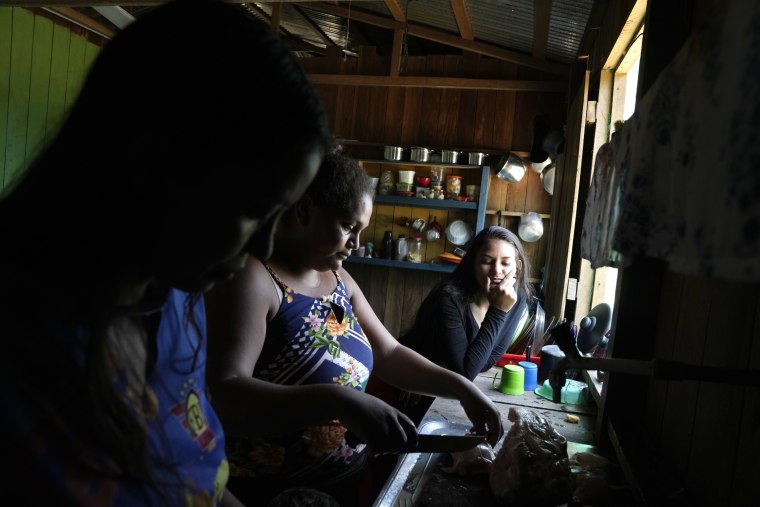 A family prepares food at a home in Lago Serrado