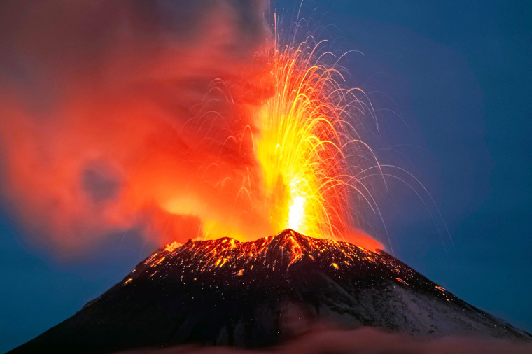 Incandescent materials, ash and smoke are spewed from the Popocatepetl volcano as seen from thr Santiago Xalitzintla community, state of Puebla, Mexico, on May 22, 2023. Mexican authorities on May 21 raised the warning level for the Popocatepetl volcano to one step below red alert, as smoke, ash and molten rock spewed into the sky posing risks to aviation and far-flung communities below. Sunday's increased alert level -- to "yellow phase three" -- comes a day after two Mexico City airports temporarily halted operations due to falling ash.