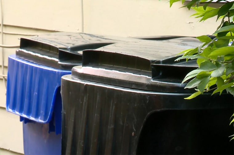Garbage cans outside the home where two infants were found dead over the weekend.