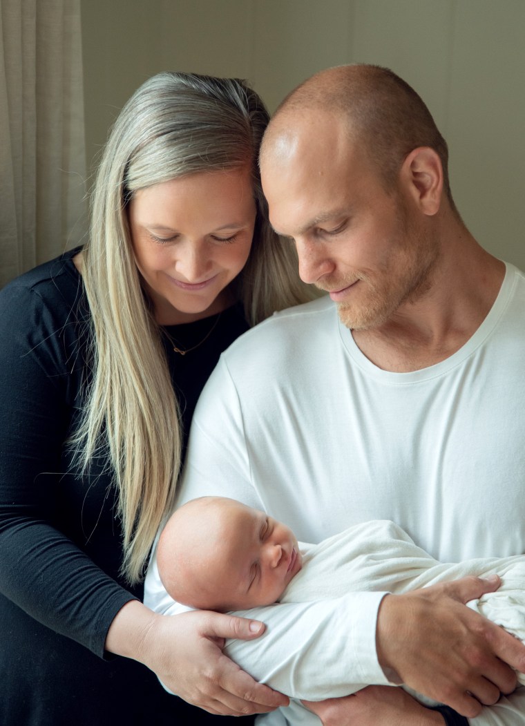Image: Kate and Brandon Movitz hold their newborn, Pierce, in 2020.
