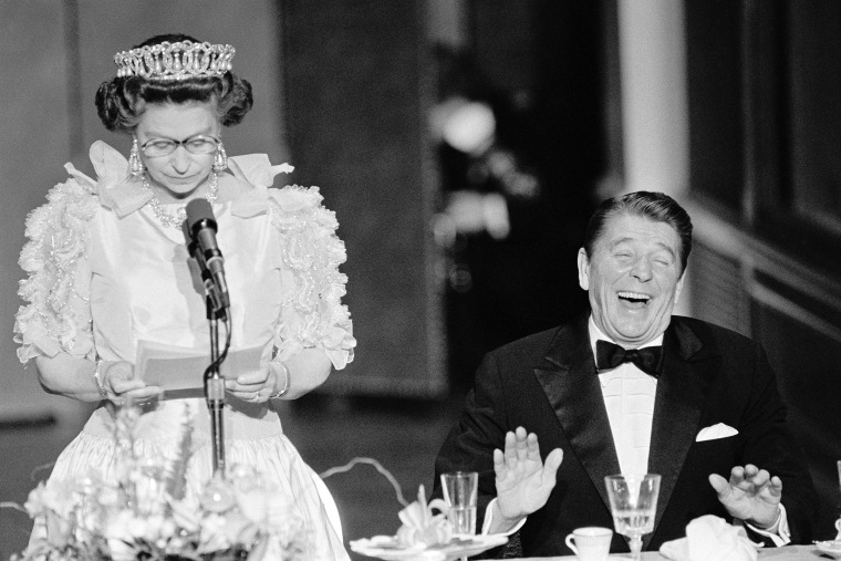President Reagan laughs following a joke by Queen Elizabeth II, who commented on the lousy California weather she has experienced during a banquet at the De Young Museum in San Francisco in 1983.