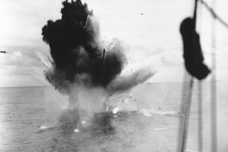 Seen from a U.S. carrier, a Japanese suicide bomber crashes into the sea off the coast of Okinawa, Japan, in June 1945.  