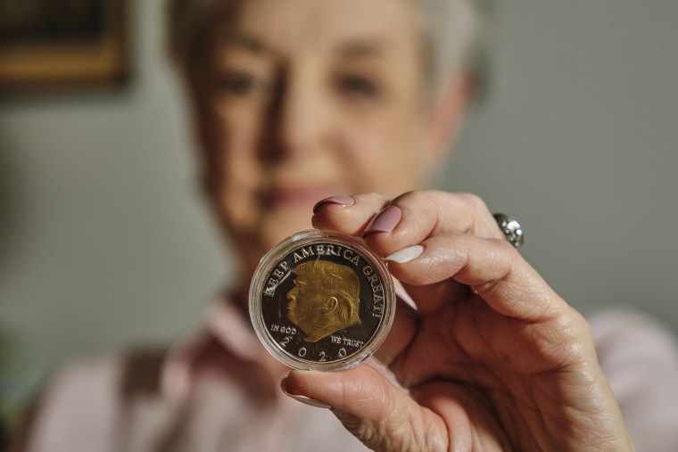 An Alabama grandmother holds one of the coins she bought online in her apartment in Mobile on May 19.
