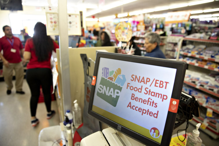 "SNAP/EBT Food Stamp Benefits Accepted" is displayed on a screen inside a Family Dollar Stores Inc. store in Chicago, Ill