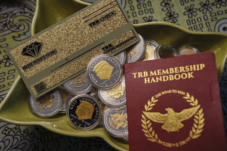 A booklet, a check and a collection of coins bought by an Alabama grandmother who invested in “Trump Bucks."