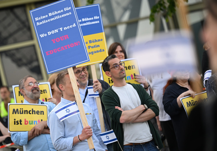 People demonstrate in front of the Olympiahalle before a Roger Waters concert in Munich