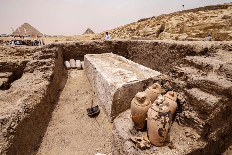 Ancient artifacts rest in a trench at the Saqqara                    necropolis in Egypt