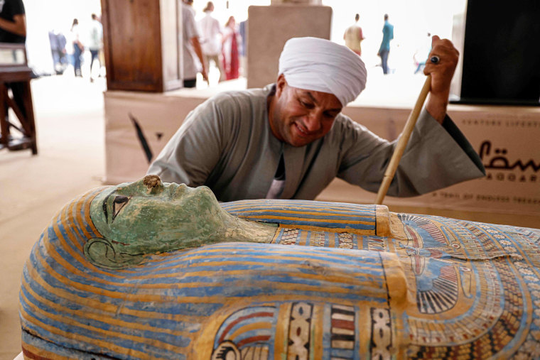 Mostafa Abdo Sadek observes a newly discovered                    sarcophagus in the Saqqara necropolis in Egypt,