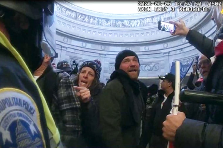 FILE - This image from Metropolitan Police Department body worn camera video and contained in the Statement of Facts supporting an arrest warrant for Pauline Bauer, pointing second to left, taken in the Rotunda of the U.S. Capitol on Jan. 6, 2021, in Washington.
