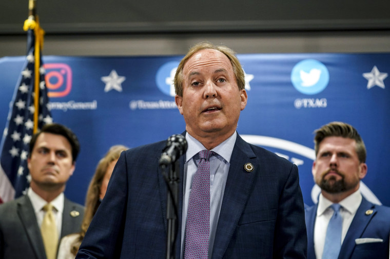 Image: Texas state Attorney General Ken Paxton reads a statement at his office in Austin, Texas on May 26, 2023.