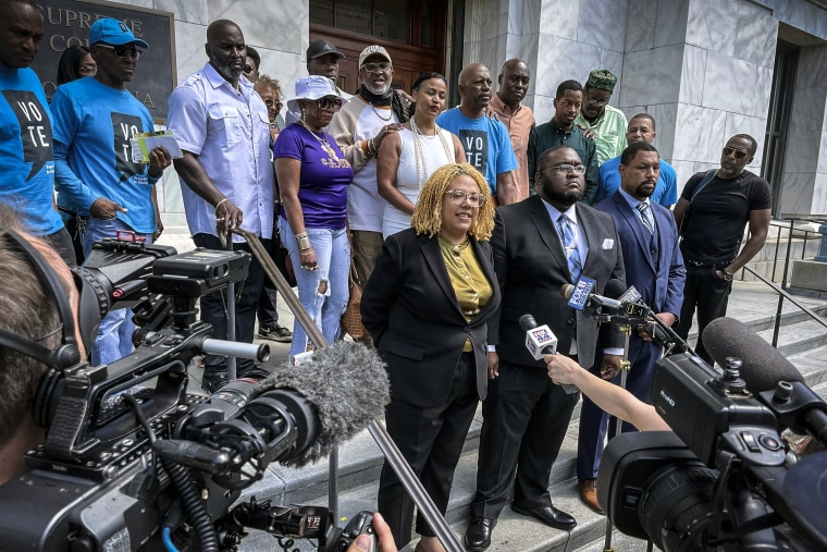 Image: Attorneys and criminal justice advocates stand outside Louisiana's Supreme Court on May 10, 2022, after arguing that people convicted by nonunanimous juries should be granted new trials.