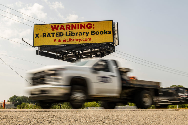 A billboard from a group challenging books in public libraries is seen near Benton, Ark., on May 25, 2023.