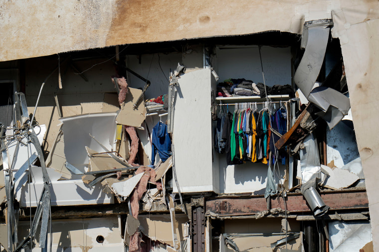 Clothing hanging in an apartment of the building that partially collapsed.