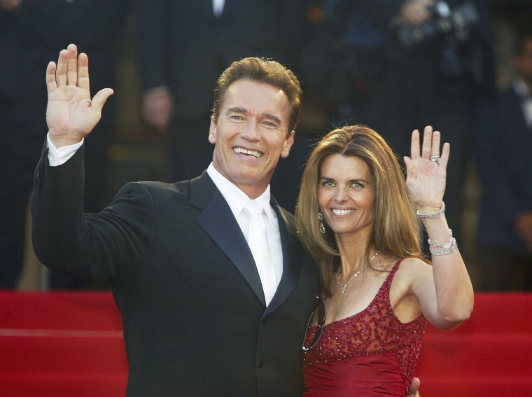Arnold Schwarzenegger with his former wife Maria Shriver wave to fans as the couple arrives for the screening of the film "Les Egares" at the Palais des Festivals during the 56th International Cannes Film Festival on May 16, 2003 in Cannes, France. 