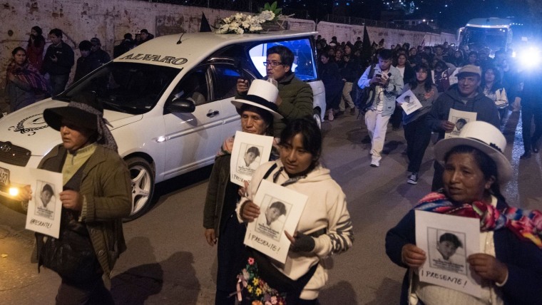Un grupo de mujeres de pueblos originarios caminan en marzo de 2023 frente a un ataúd sosteniendo una foto de Rosalino Florez, estudiante peruano que fue de las más de 60 personas que murieron en protestas antigubernamentales entre diciembre y febrero 