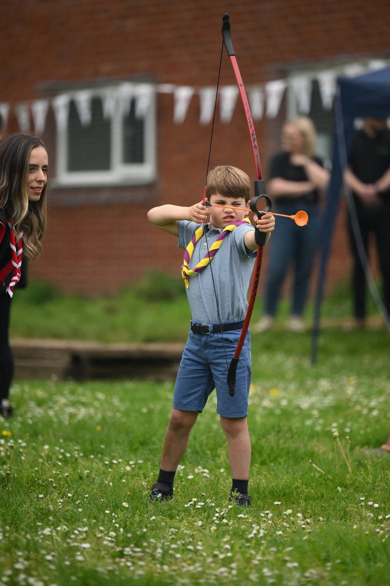 Prince Louis of Wales tries his hand at archery while taking part in the Big Help Out, during a visit to the 3rd Upton Scouts Hut in Slough, west of London on May 8, 2023, where the family joined volunteers helping to renovate and improve the building. 