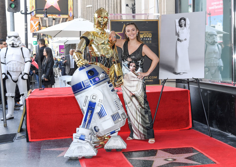 Billie Lourd with R2D2 and C3PO.