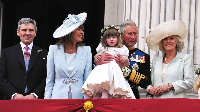 Michael Middleton, Carole Middleton, Prince Charles, Prince of Wales holding bridesmaid Eliza Lopes and the Camilla, Duchess of Cornwall on the balcony at Buckingham Palace after the Royal Wedding of Prince William to Catherine Middleton on April 29, 2011 in London, England. 