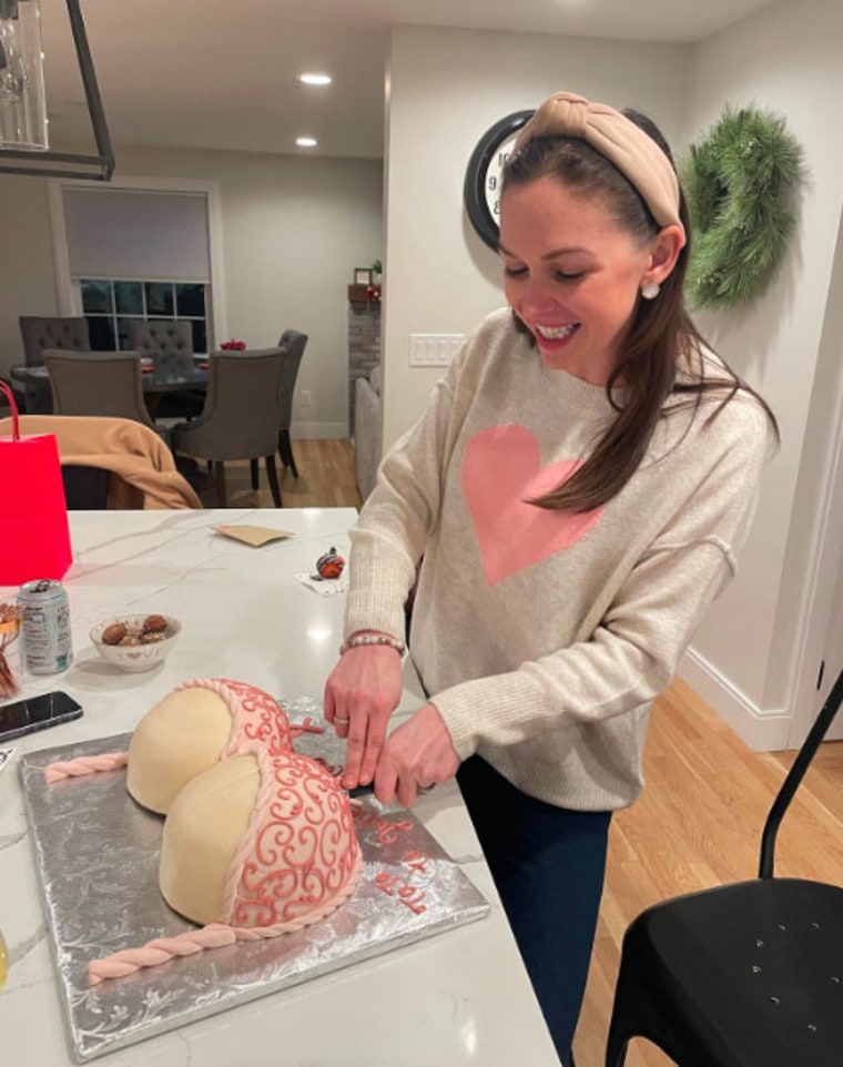 Julie cutting a boob cake for her "boob voyage" party