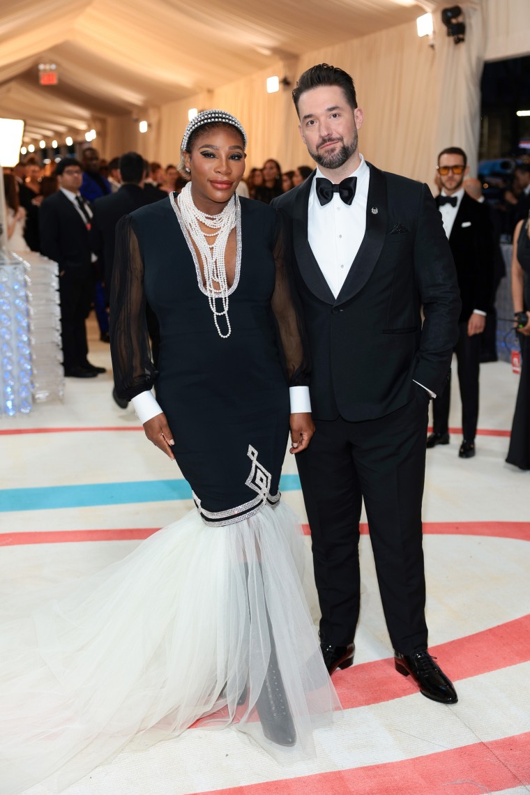 The couple posing at the fashion event.