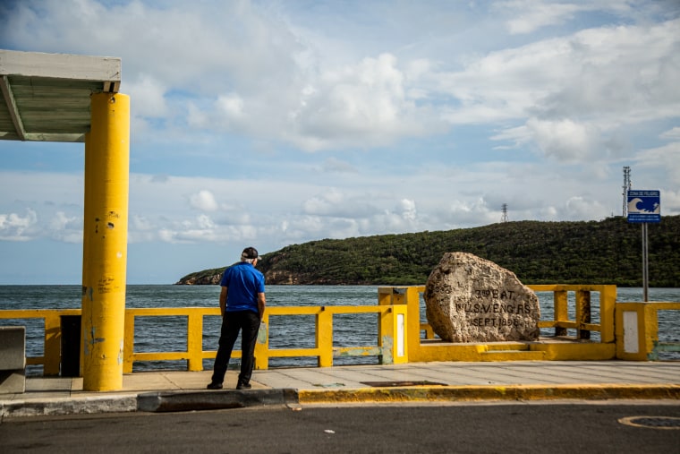 A man stands next to the monument that marks where the U.S. invaded Puerto Rico in 1898 at the Guanica Bay in Guanica on May 29, 2023.