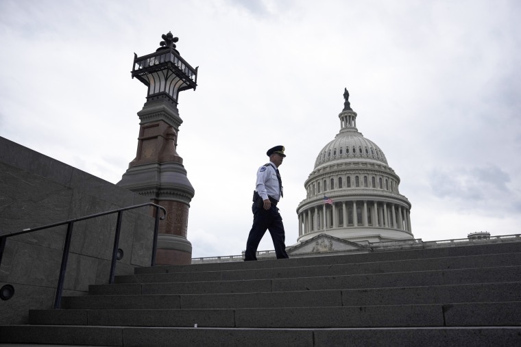  A police officer walks along the East Front of the Capitol