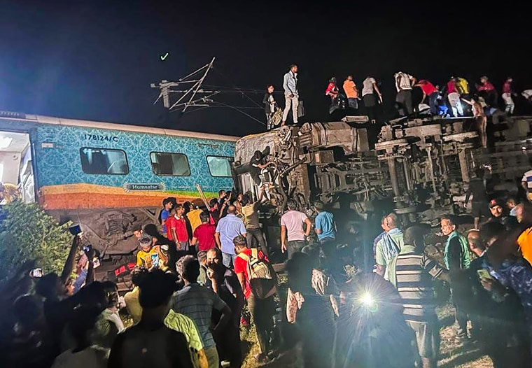 Rescuers work at the site of a derailed train in Balasore district, India