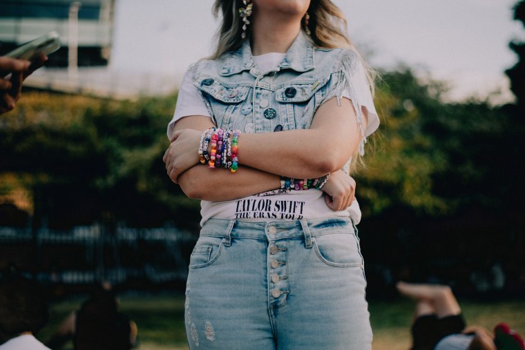 Samantha Funk, 28, spent her Friday night outside Soldier Field in Chicago to listen to Taylor Swift's concert, share friendship bracelets and dance.