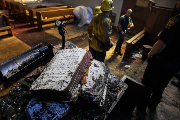 A singed hymnal on the pulpit in the aftermath of a fire at St. Johns United Methodist Church in Los Angeles, Calif.