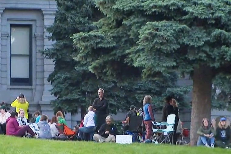 Women hold a sit-in at the Colorado Capitol on Monday to push for an end to gun violence.