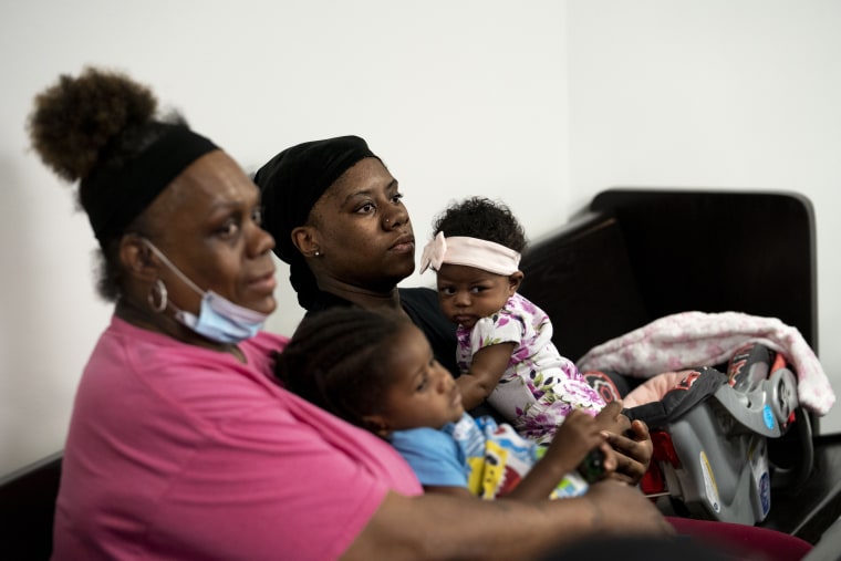 Brittany Jennings holds her two-month old daughter Si'Yere Jackson while waiting with her mom, Helen Jennings, who's holding Brittany's son Cincere Jackson, 2, at housing court in the 36th District Court in Detroit, Mich., on June 5, 2023.