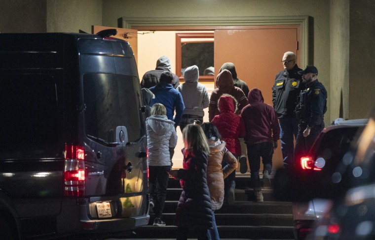 A van load of people are brought to the family reunification center at the IDES Hall in Half Moon Bay, Calif.