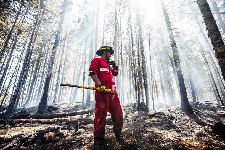 Image: Halifax Regional Fire and Emergency firefighter Zach Rafuse from Port Williams works to put out fires in the Tantallon area of Nova Scotia on May 30, 2023.