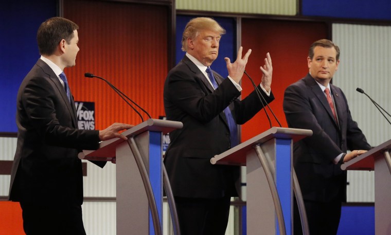 Republican U.S. presidential candidate Trump shows off the size of his hands as rivals Rubio and Cruz look on at the start of the U.S. Republican presidential candidates debate in Detroit