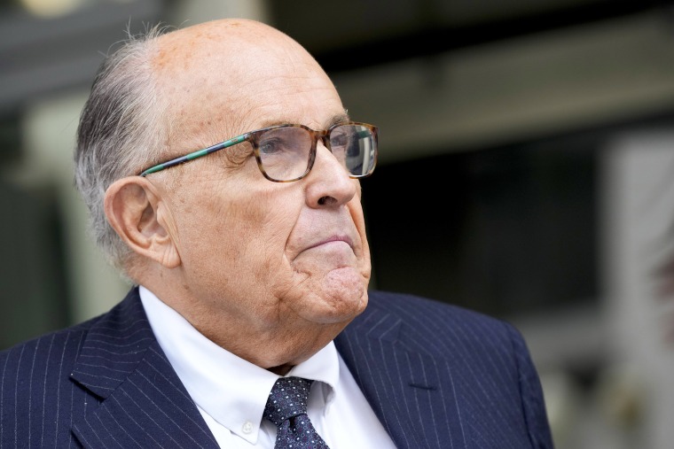 FILE - Rudy Giuliani speaks with reporters as he departs the federal courthouse, May 19, 2023, in Washington. Giuliani, the former mayor of New York City, says a woman’s lawsuit alleging he coerced her into sex and owes her nearly $2 million in unpaid wages is “a large stretch of the imagination” filled with exaggerations and salacious details “to create a media frenzy.”