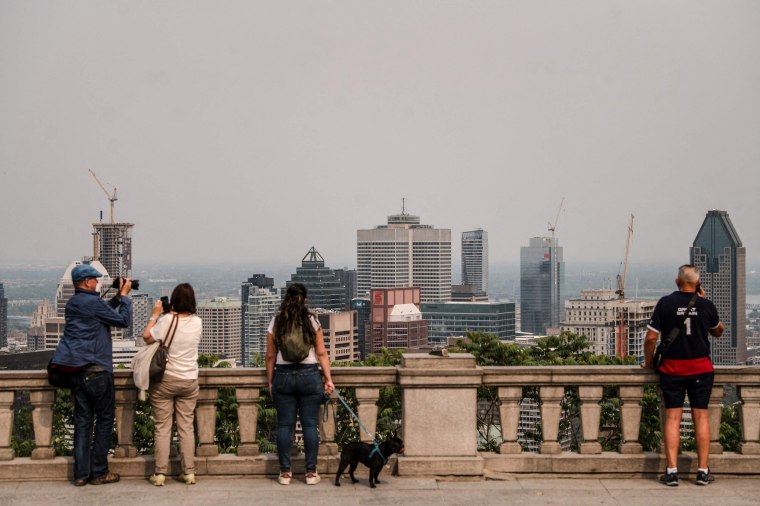 Image: People look out at the city covered in smoke, from the chalet on top of the Mont Royal in Montreal, Quebec, Canada, on June 5, 2023.