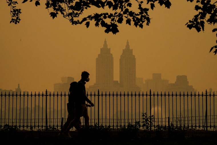 Image: People walk in Central Park as smoke from wildfires in Canada cause hazy conditions in New York on June 7, 2023.