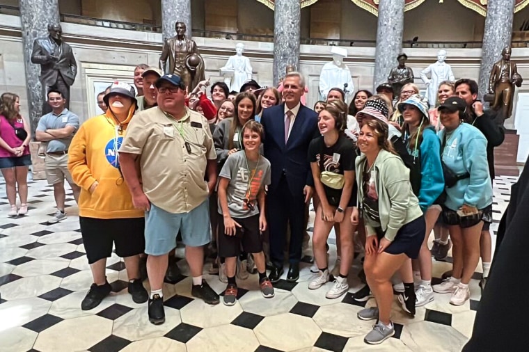 House Speaker Kevin McCarthy poses with the tourists in the U.S. Capitol on June 8, 2023.