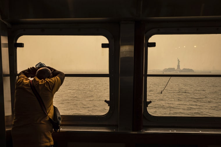 Image: The Statue of Liberty, covered in a haze-filled sky, from the Staten Island Ferry, on June 7, 2023, in New York.