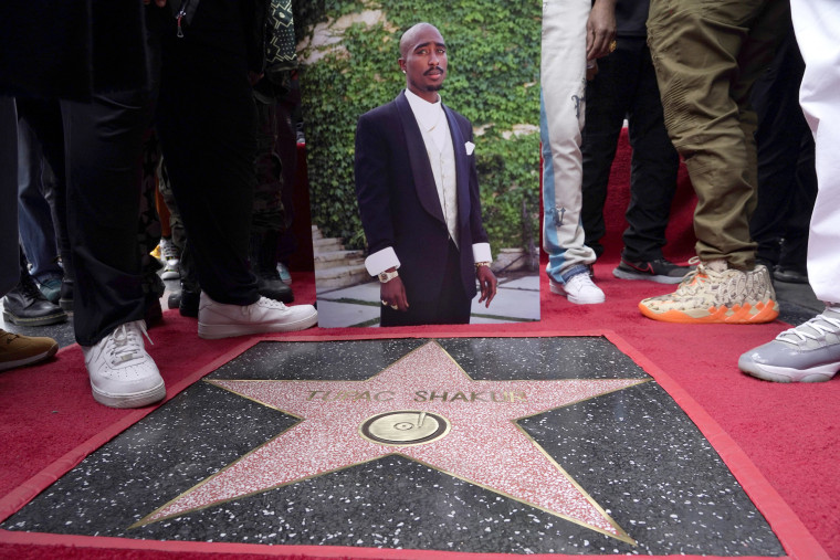 An image of Tupac Shakur appears near his new star on the Hollywood Walk of Fame during a posthumous ceremony in his honor in Los Angeles