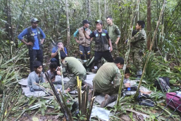 In this photo released by Colombia's Armed Forces Press Office, soldiers and Indigenous men tend to the four Indigenous brothers who were missing after a deadly plane crash, in the Solano jungle, Caqueta state, Colombia, Friday, June 9, 2023. Colombian President Gustavo Petro said Friday that authorities found alive the four children who survived a small plane crash 40 days ago and had been the subject of an intense search in the Amazon jungle. 