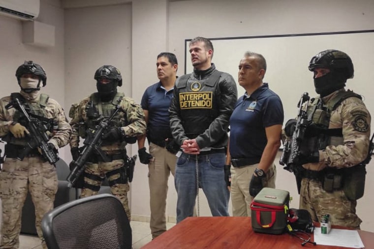 Peruvian police and Interpol agents handing over Joran Van der Sloot to FBI agents for a temporary extradition to the United States in Callao, Peru