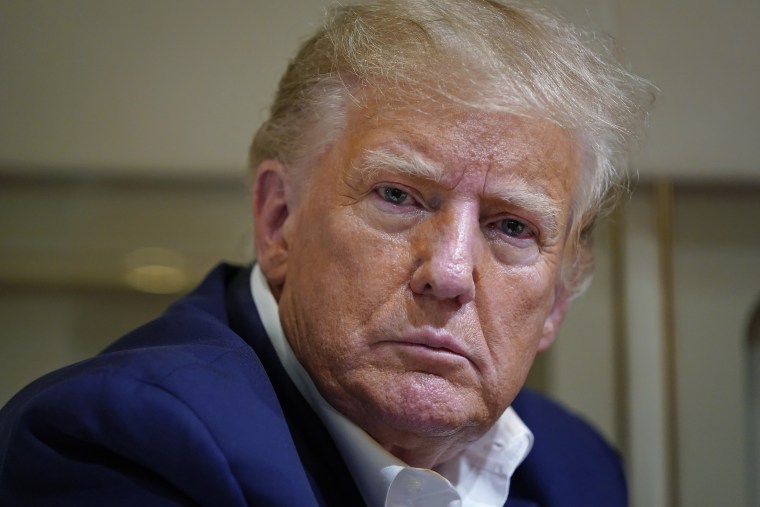 Former President Donald Trump speaks with reporters on his plane after a campaign rally in Waco, Texas, on March 25, 2023. 