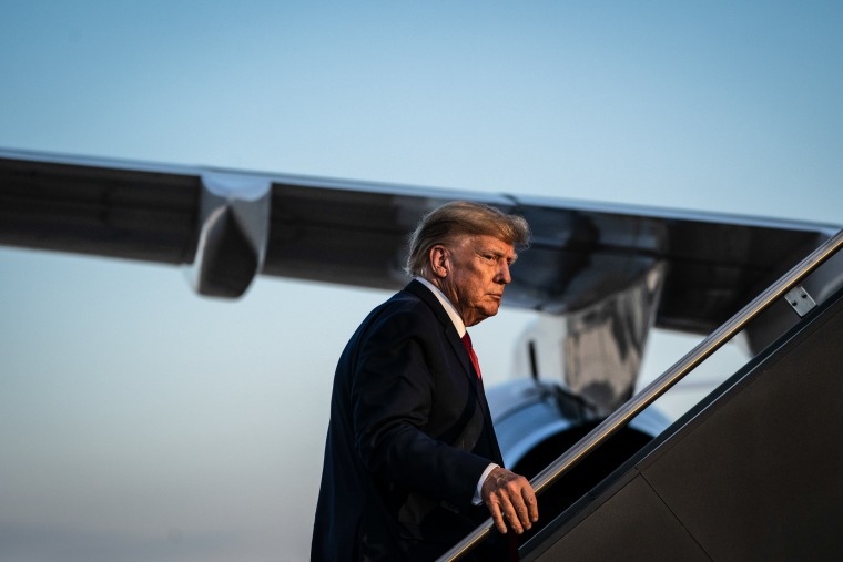 Former President Donald Trump boards his airplane after speaking at a campaign event on April 27, 2023, in Manchester, NH.