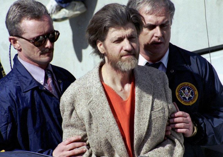 Theodore "Ted" Kaczynski is is escorted from the federal courthouse in Helena, Mont